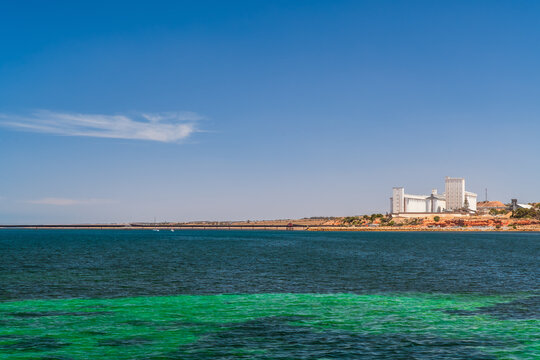The Ardrossan coastline and bulk grain storage facility are viewed across the shallow waters of Gulf St Vincent from Ardrossan Jetty on Yorke Peninsula, South Australia. 