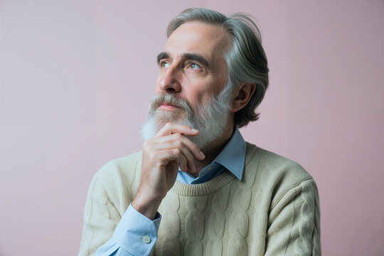Senior Caucasian man posing with hand on chin and looking away, expressing thoughtful decision making and reflection. Useful for retirement planning, wisdom, strategy messaging
