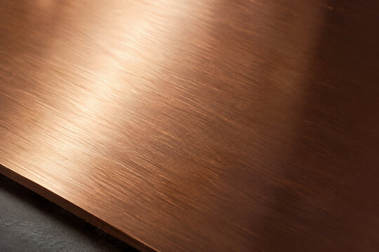 Brushed copper sheet with warm reflected light