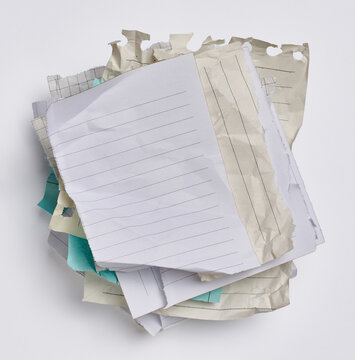 Empty various blank crumpled pieces of sheets torn from a notebook on a white background