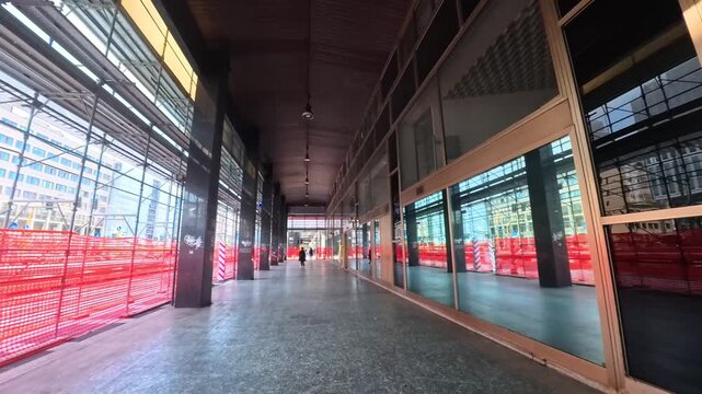 Walking Beneath an Urban Building Portico During Renovation With Scaffolding and Morning Commuters, Milan, Italy - POV VIDEO - NO AUDIO