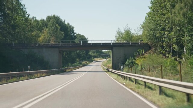 View of the road through the car's windshield slow motion an oncoming car and a truck