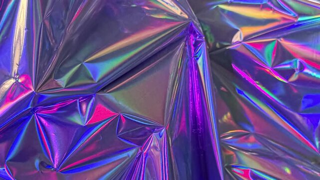 Iridescent crumpled foil texture abstract background