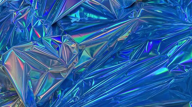 Blue holographic crumpled foil texture background