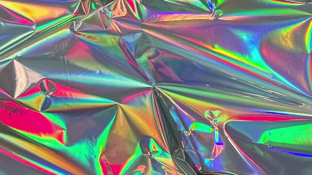 Iridescent crumpled foil texture background