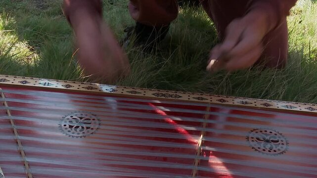 Close-up: a young man playing the cimbalom with wooden mallets. Великий план: хлопець грає
 на цимбалах дерев&rsquo;яними паличками