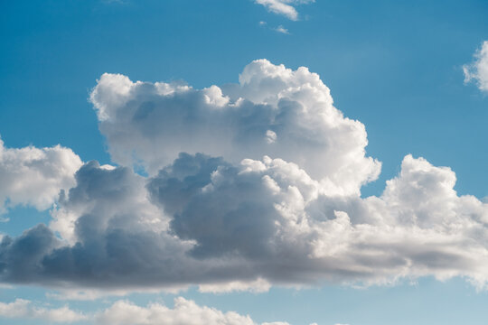 View of fluffy white cumulus clouds drifting across a bright blue sky in Novi Sad, Vojvodina, Serbia.