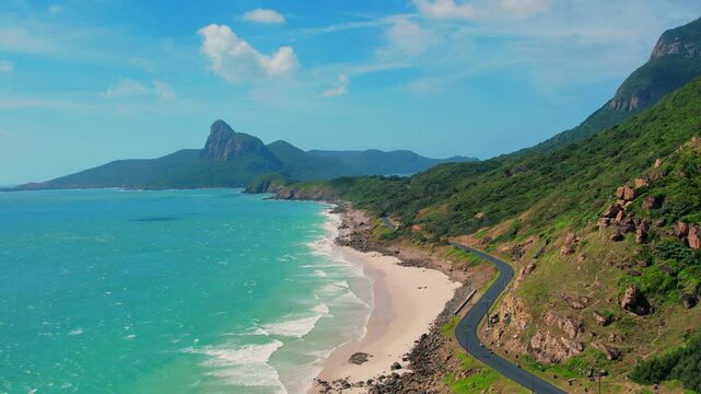 High aerial view of coastal road and emerald sea in Con Dao

