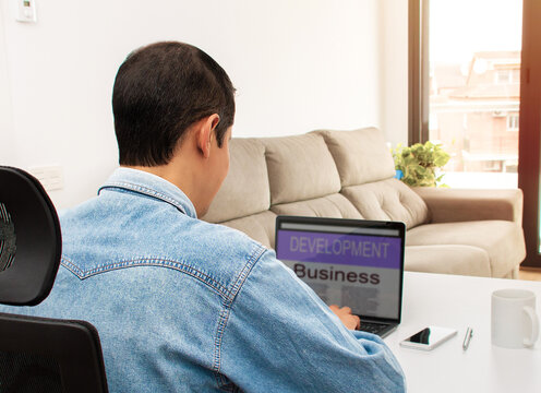 Man working online at home on a laptop