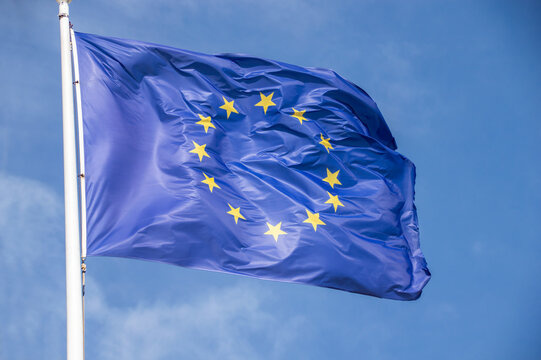 The europe flag with blue sky in background in sunny day