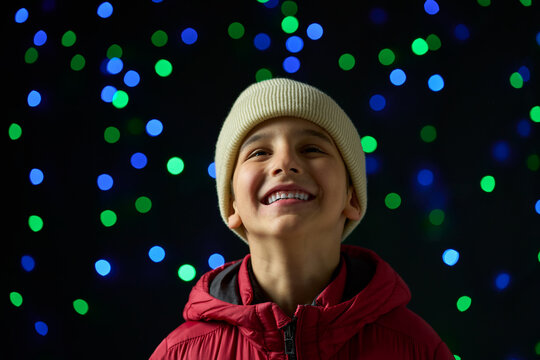 Child enjoying the Christmas spirit with Christmas decorations outside the city.
