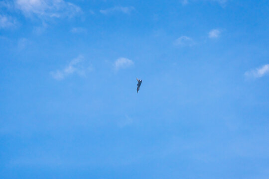 View of a fighter jet flying high in the clear blue sky above Mosnov, Moravian-Silesian Region, Czechia.