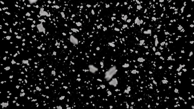 Dense ash falling like grey snow on black