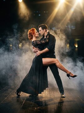 Passionate Professional Ballroom Dancers Performing Tango on a Smoky Stage with Dramatic Lighting