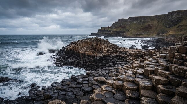 Volcanic basalt columns on a rugged coastline, dramatic ocean waves hitting hexagonal rock formations, moody coastal landscape under dark clouds