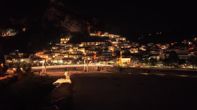 Aerial Approach to Berat Night Cityscape and Illuminated Bridge