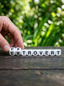 Psychology Concept of Personality Type: Hand Flipping Dice to Change Introvert to Extrovert
