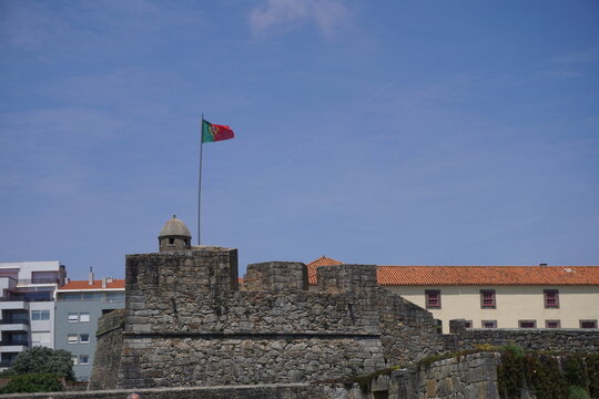 portugal flag over a medieval forteress 