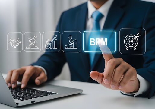 Businessman in blue suit pointing at business process management button on virtual screen with laptop