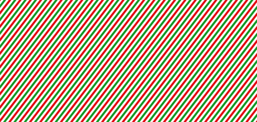Fototapeta premium Christmas red, green and white diagonal stripes seamless pattern. Festive candy cane wrapping paper texture. Geometric vector background.