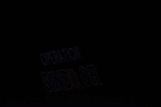 drone light view of operation sindoor written against a dark background