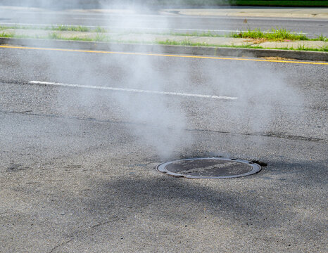 Smoke Rises from a Manhole on Canal Street in Mid City Neighborhood of New Orleans, LA, USA