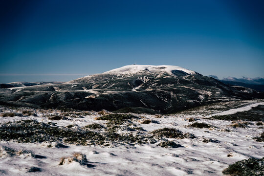 View of the snow-covered Golyam Kademliya peak in the Central Balkan Mountains with a clear blue sky and winter landscape in Stara Zagora, Bulgaria.