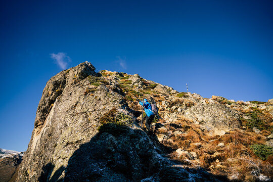 View of a hiker climbing the rocky terrain near Golyam Kademliya Shelter in Stara Zagora, Bulgaria.