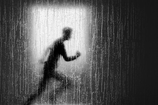 3D sprinting human figure behind wet glass with motion blur and cinematic backlight