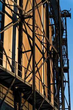 View of the intricate steel framework and metal panels of an industrial building under a clear blue sky in Ostrava, Moravian-Silesian Reg, Czechia.