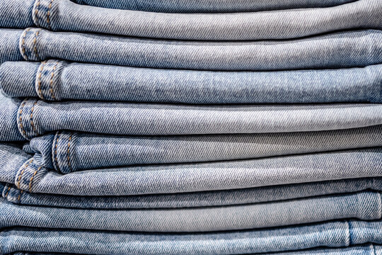 Stacked blue denim jeans folded neatly in a retail store