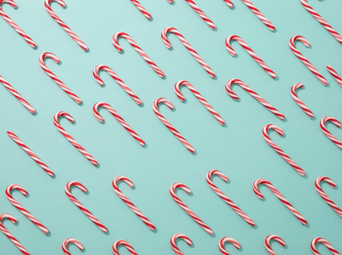Candy cane pattern flat lay on light blue background