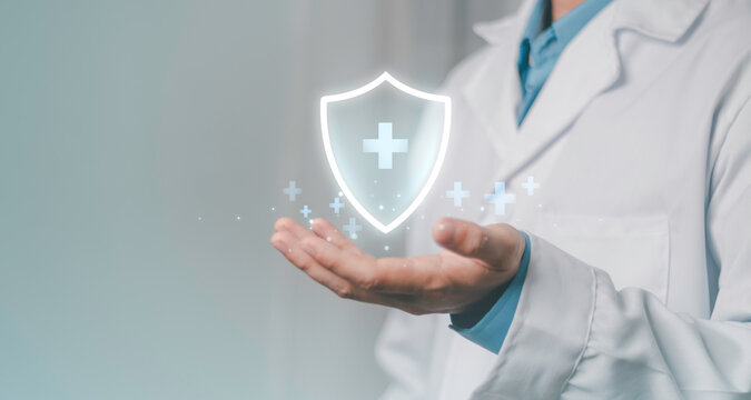 Healthcare protection, insurance coverage, patient safety, prevention, and care. Medical insurance concept, doctor presenting a digital health shield with medical symbols.