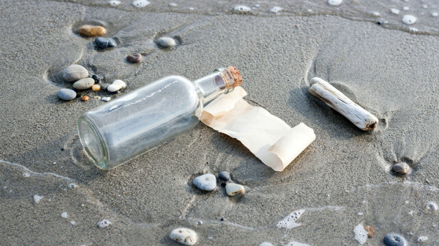 A message in a bottle washed up on a sandy beach