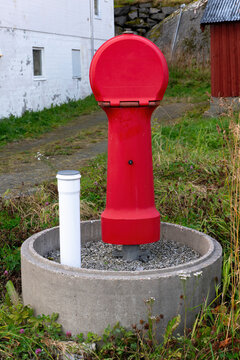 Red Norwegian fire hydrant in a rural setting