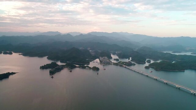 Aerial View of Lake with Islands, Bridge and Mountains at Sunrise in Thousand Island Lake, Zhejiang, China