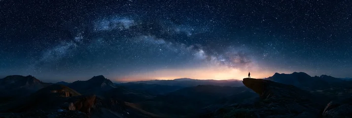 Lone Hiker on Mountain Peak Under Milky Way Starry Night Sky © Jonas Weinitschke