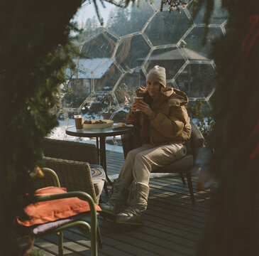 Woman Enjoying Coffee at a Winter Mountain Cafe