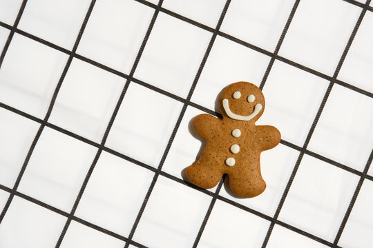 Smiling Gingerbread Cookie On Graphic Black And White Checkered Cloth