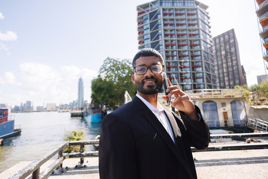 Young businessman talking on phone in London city