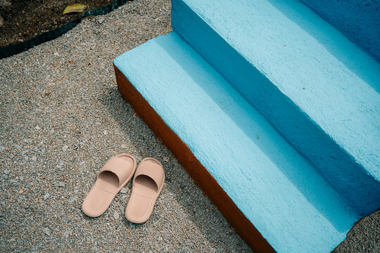 Sandals Placed Near Colorful Stairs in Outdoor Area