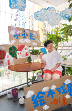Chinese female teacher and the props she made for a drama class