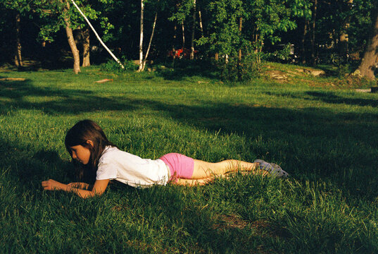 Girl lying in a grassy field in summer