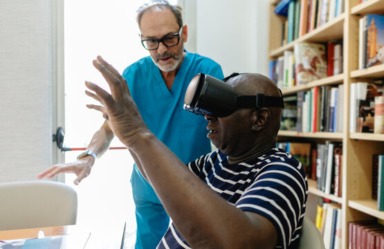 Senior man experiencing virtual reality for rehabilitation therapy