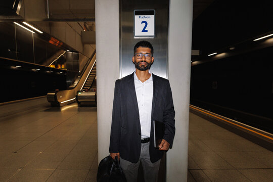 Young businessman waiting on subway platform 2