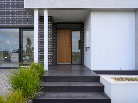 Modern Home Entrance With Steps and Greenery
