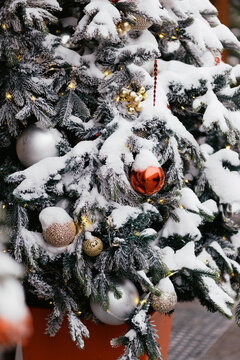 Decorated Christmas Tree Covered in Snow in a Festive Setting