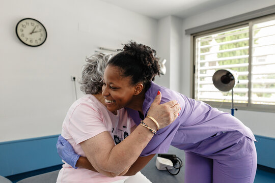 Caregiver embracing senior woman showing support and care