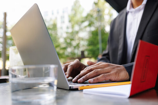 Young businessman working laptop outdoors in city