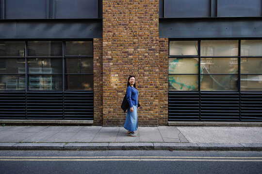 Young Filipina woman smiling on London street